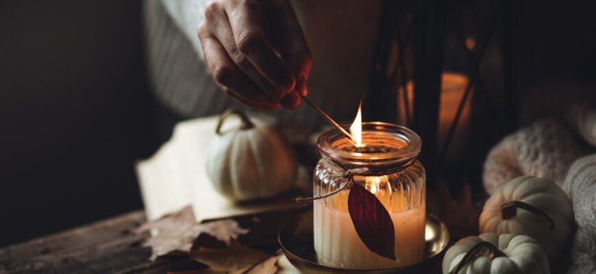 Young,Woman,In,The,Knitted,Warm,Sweater,Lights,A,Candle